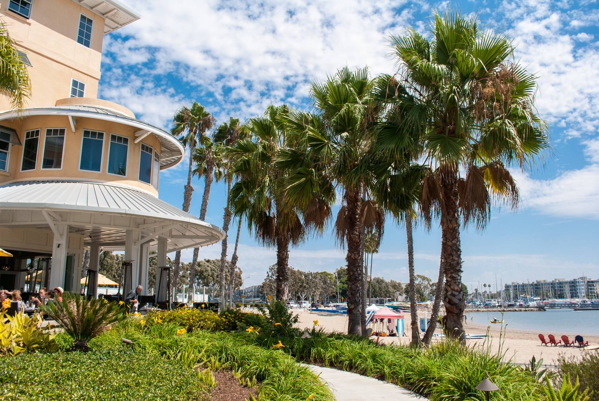 a building with palm trees and a beach
