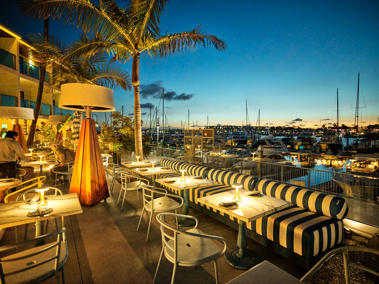 a restaurant with tables and chairs on a deck