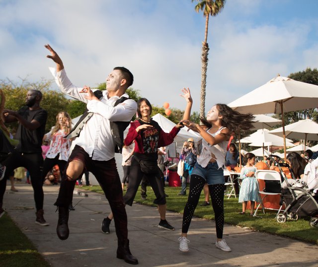 a group of people dancing outside