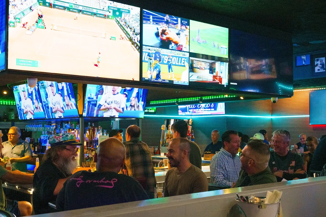 a group of people sitting at a bar