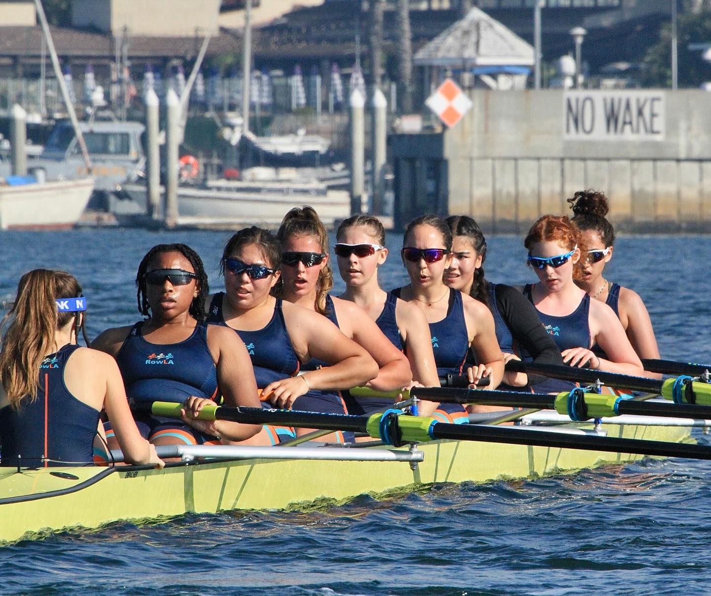 a group of women rowing a boat
