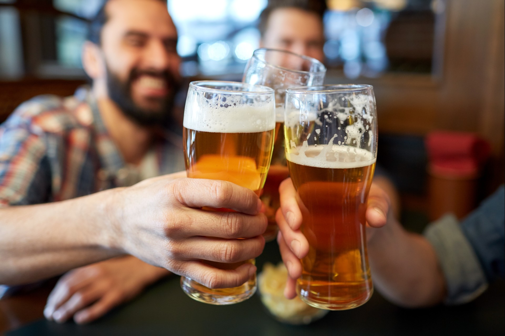 a group of people holding glasses of beer