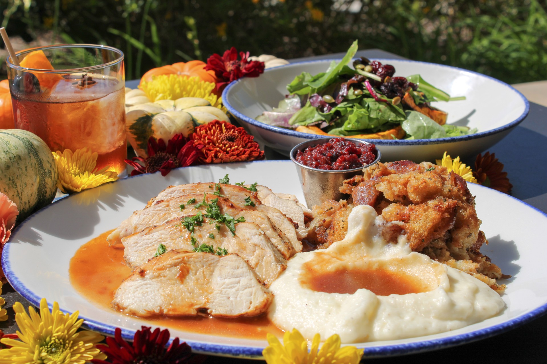 a plate of food with flowers and a drink