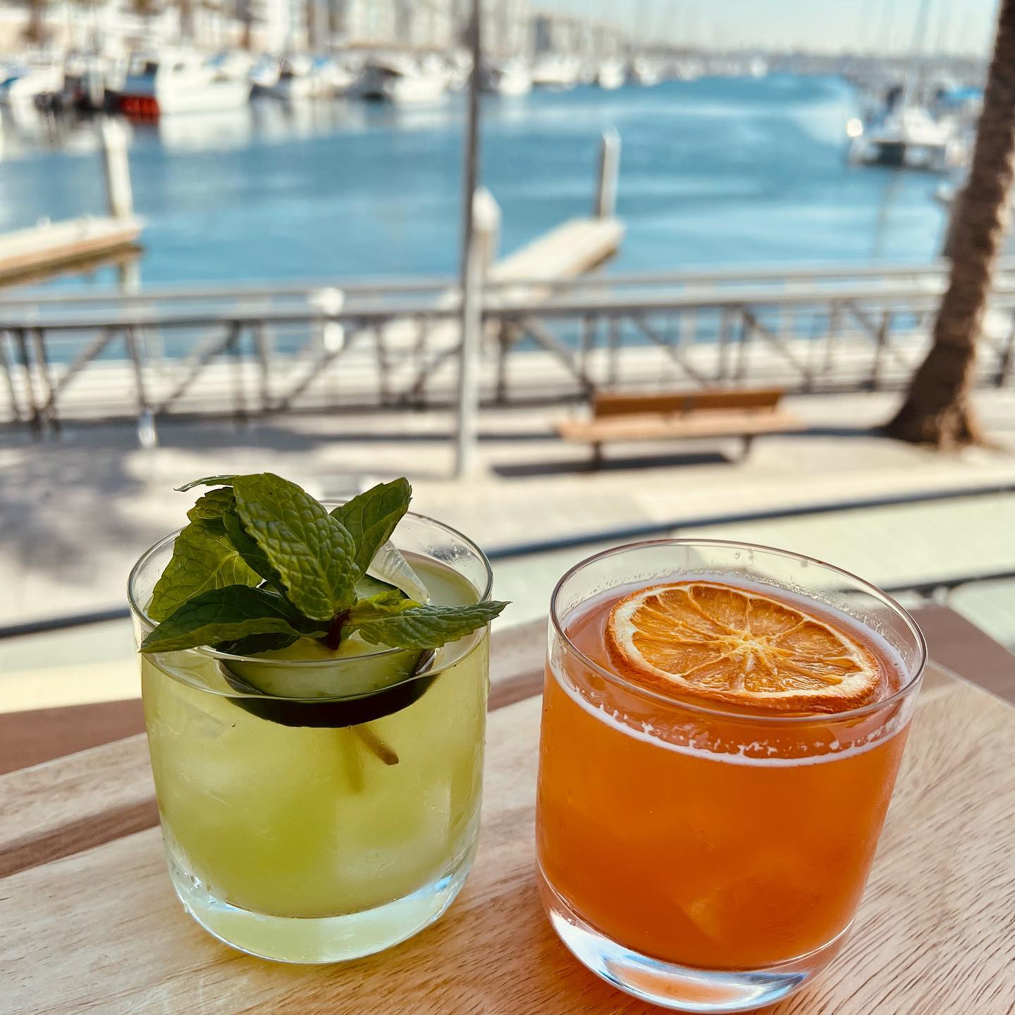 two glasses of drinks on a table