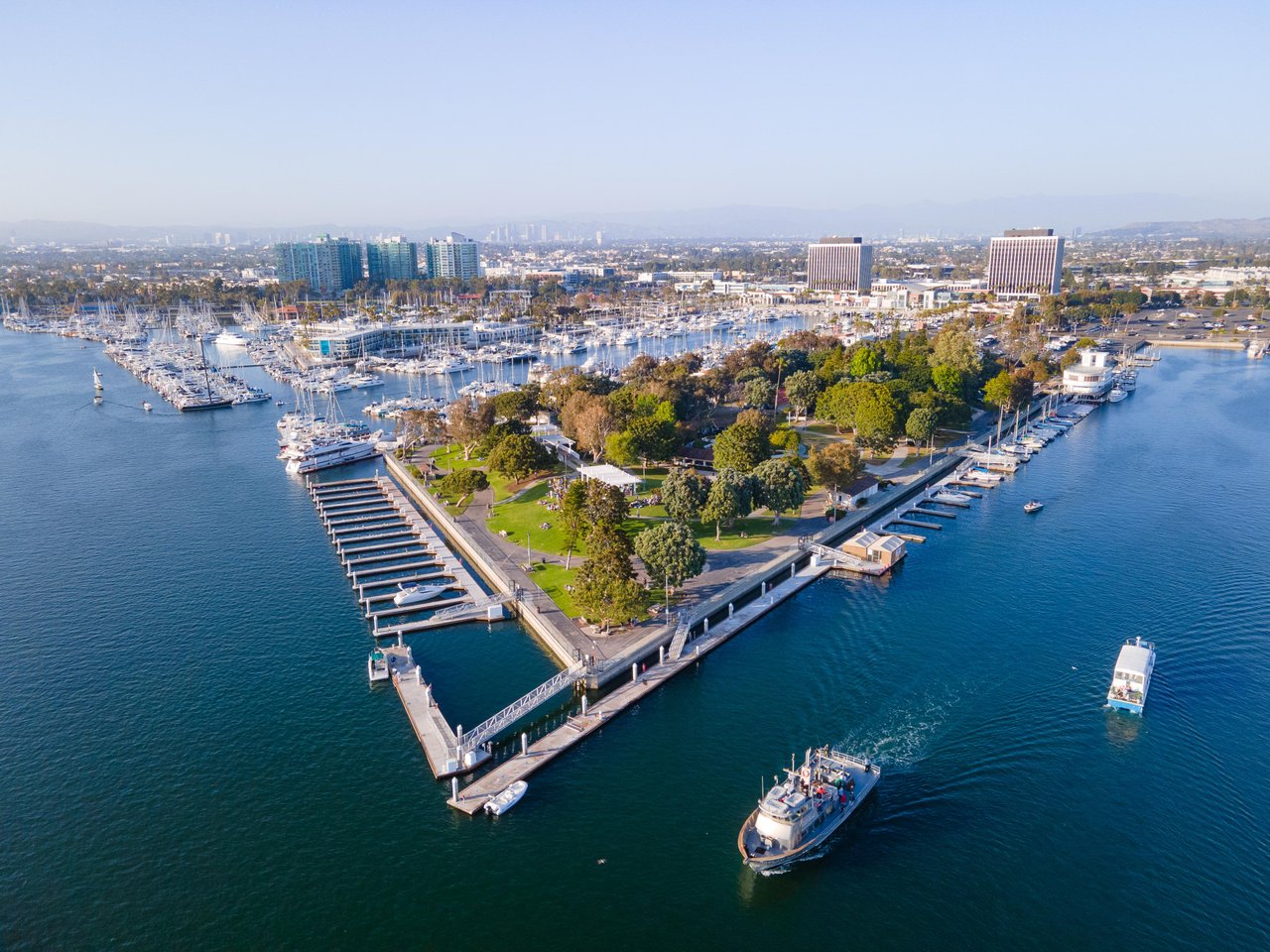 a aerial view of a harbor with boats and a park