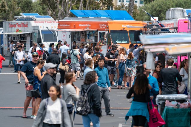 a group of people standing in a parking lot