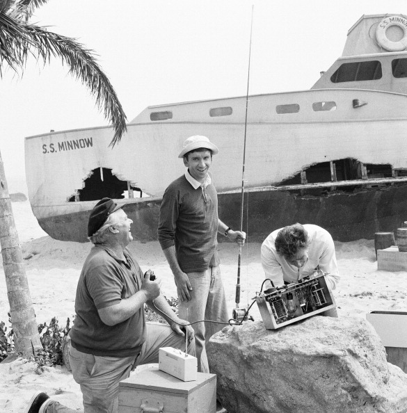 a group of men standing on a beach