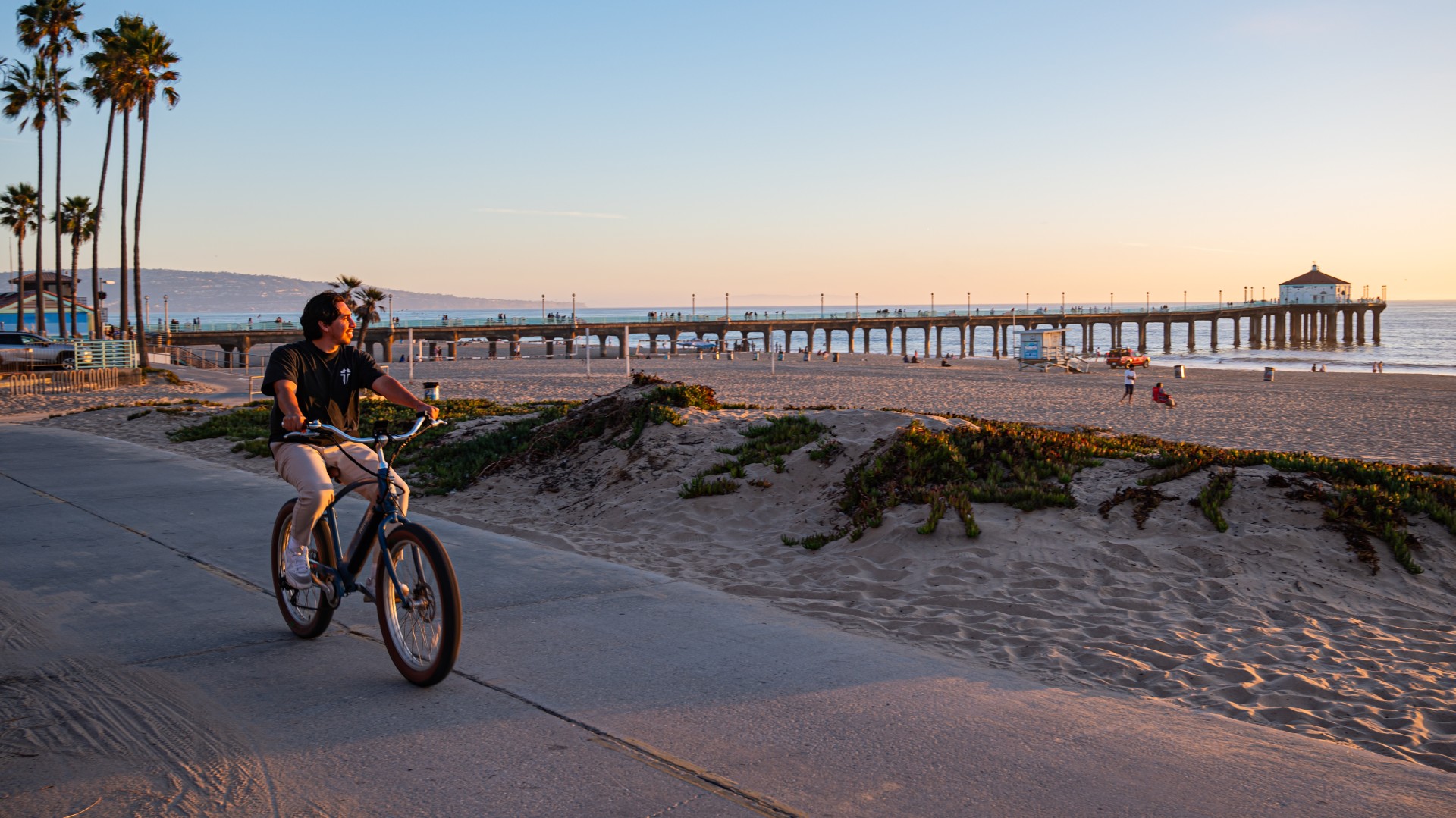 a man riding a bicycle on a beach