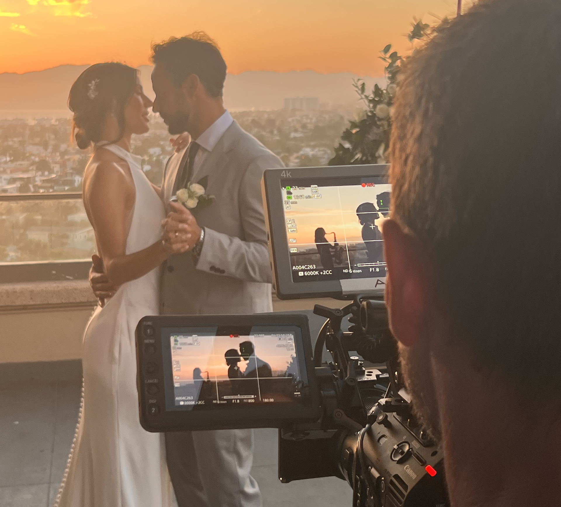a man and woman kissing in front of a camera