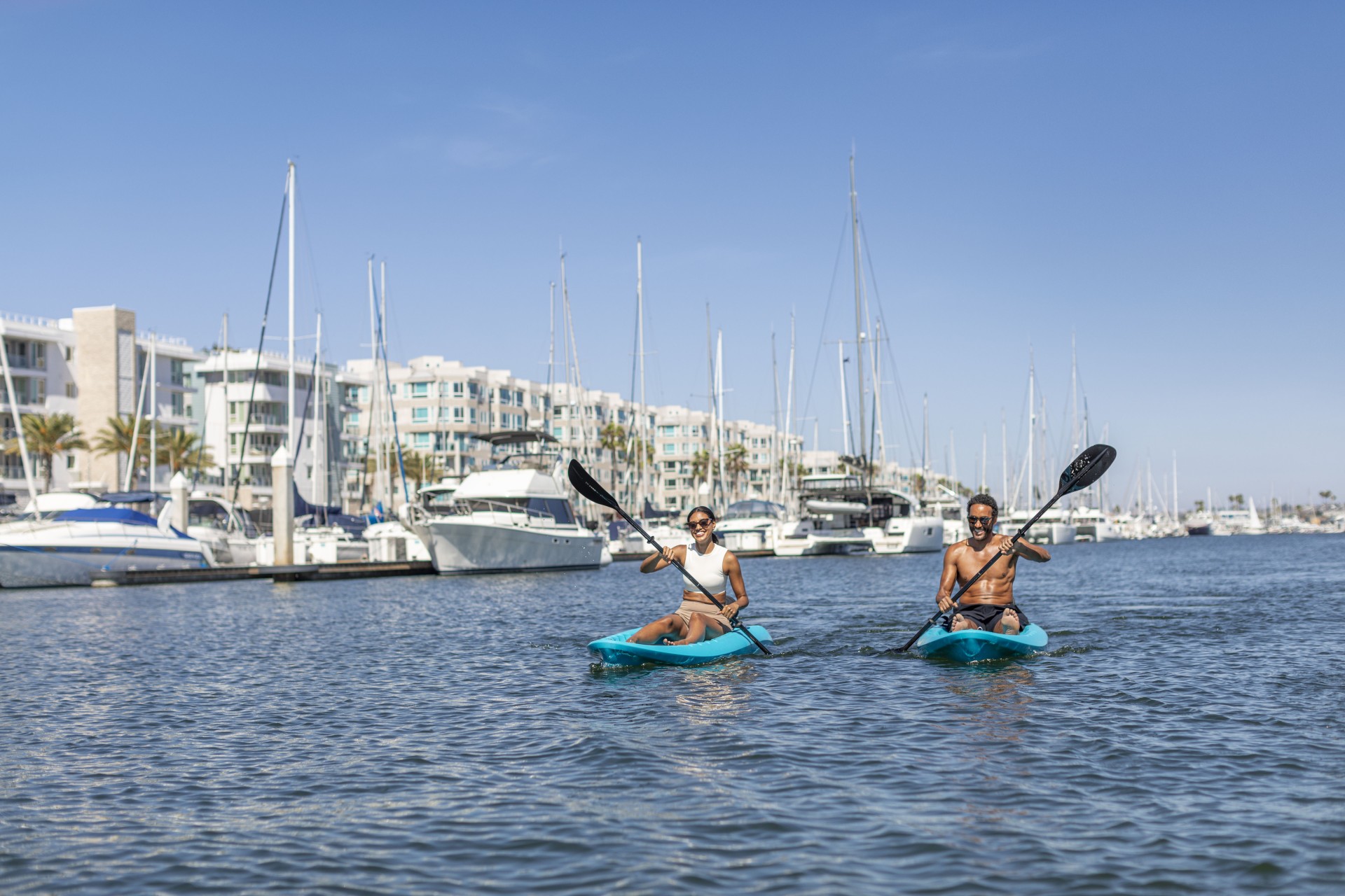 a man and woman kayaking on a body of water