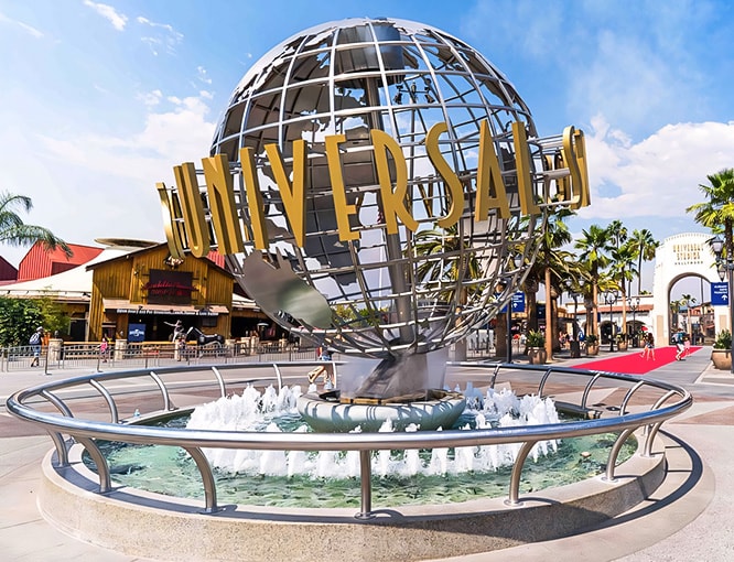a large globe shaped fountain in front of a building