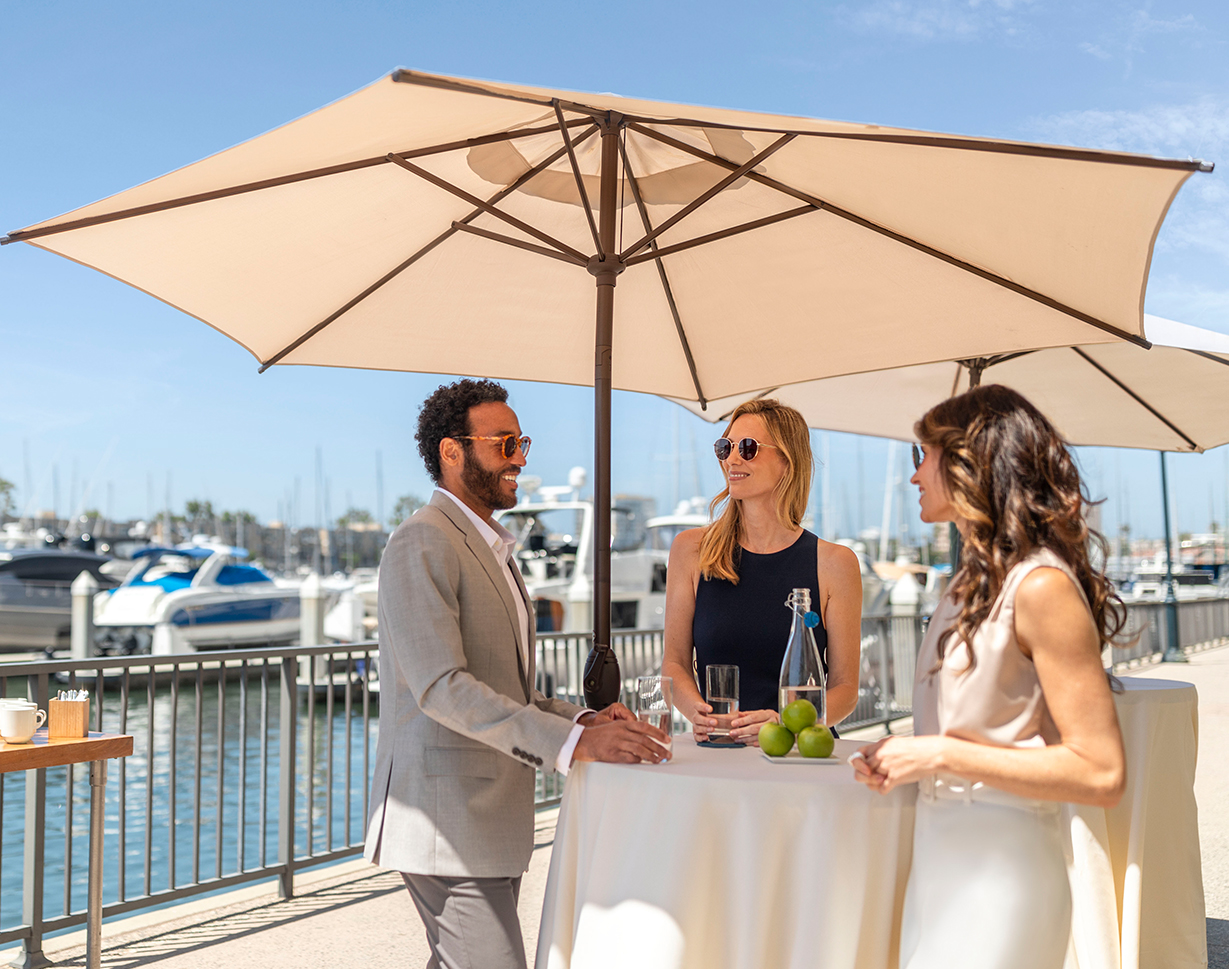 a group of people standing under an umbrella