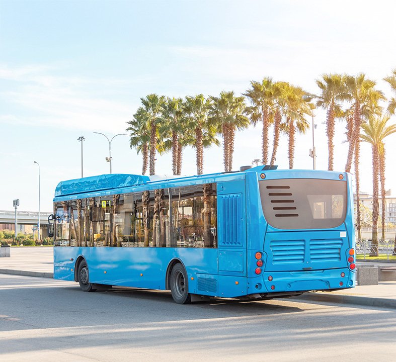 a blue bus parked on a street