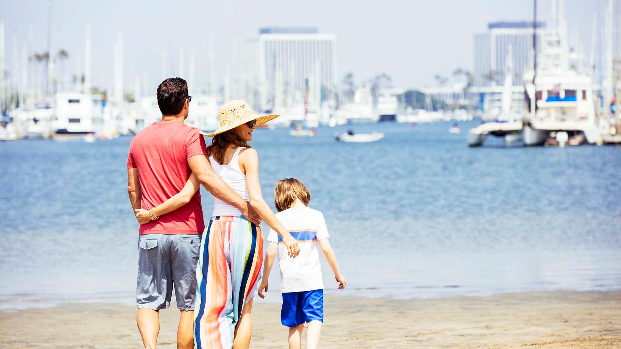 a group of people walking on a beach
