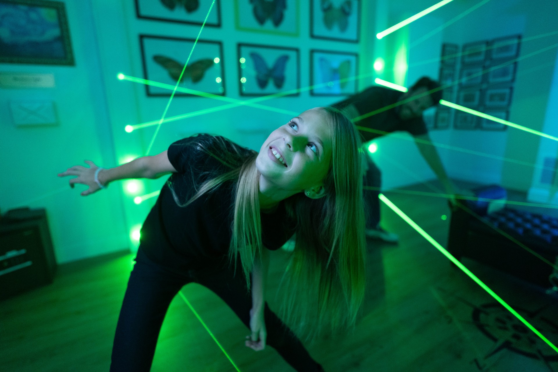a girl in a room with green lights