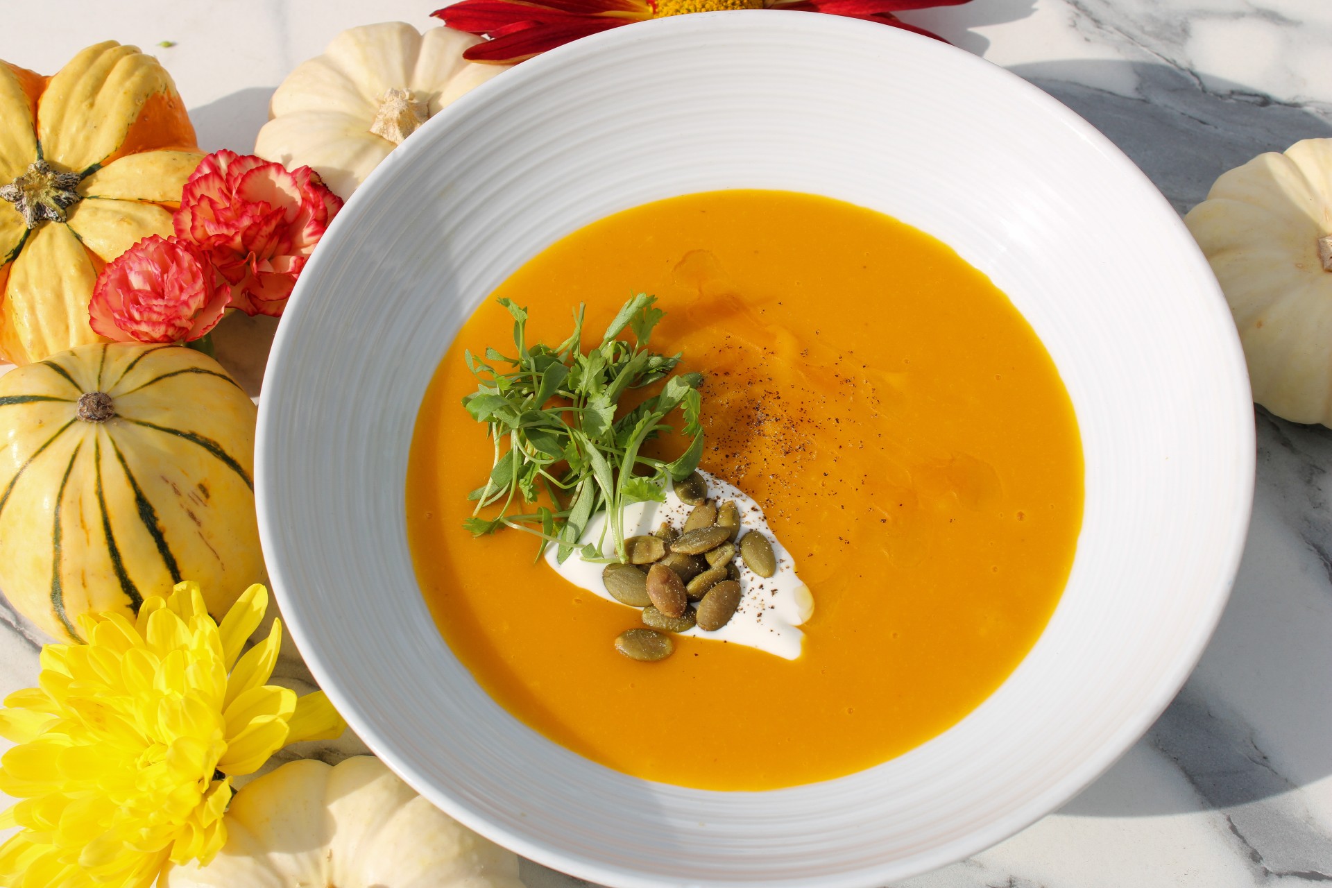 a bowl of soup with seeds and herbs