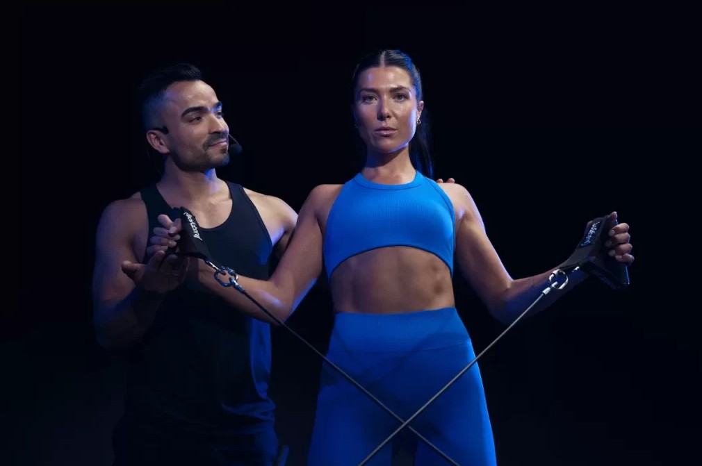 a man and woman holding exercise equipment