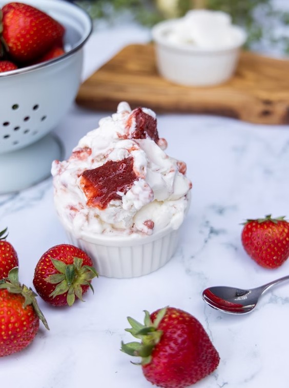 a bowl of ice cream with strawberries