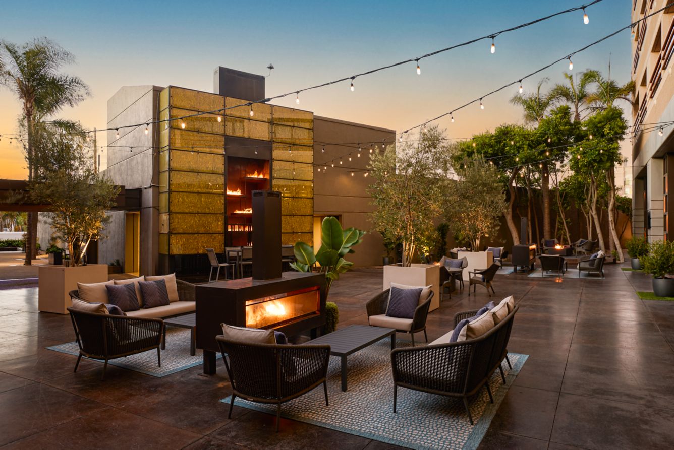 a patio with chairs and a fireplace