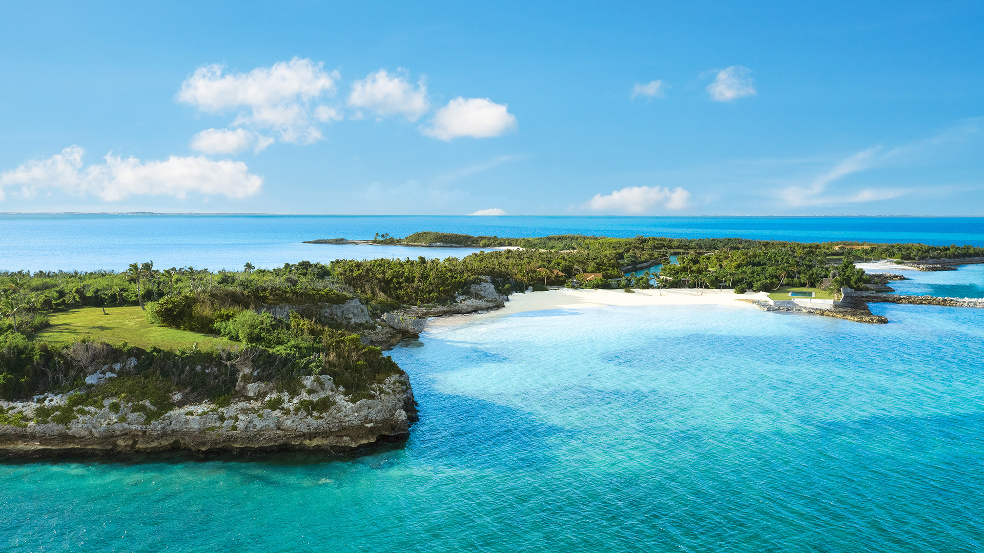 a small island with trees and blue water