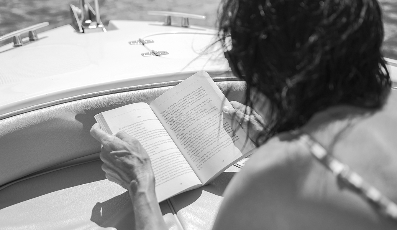 a woman reading a book on a boat
