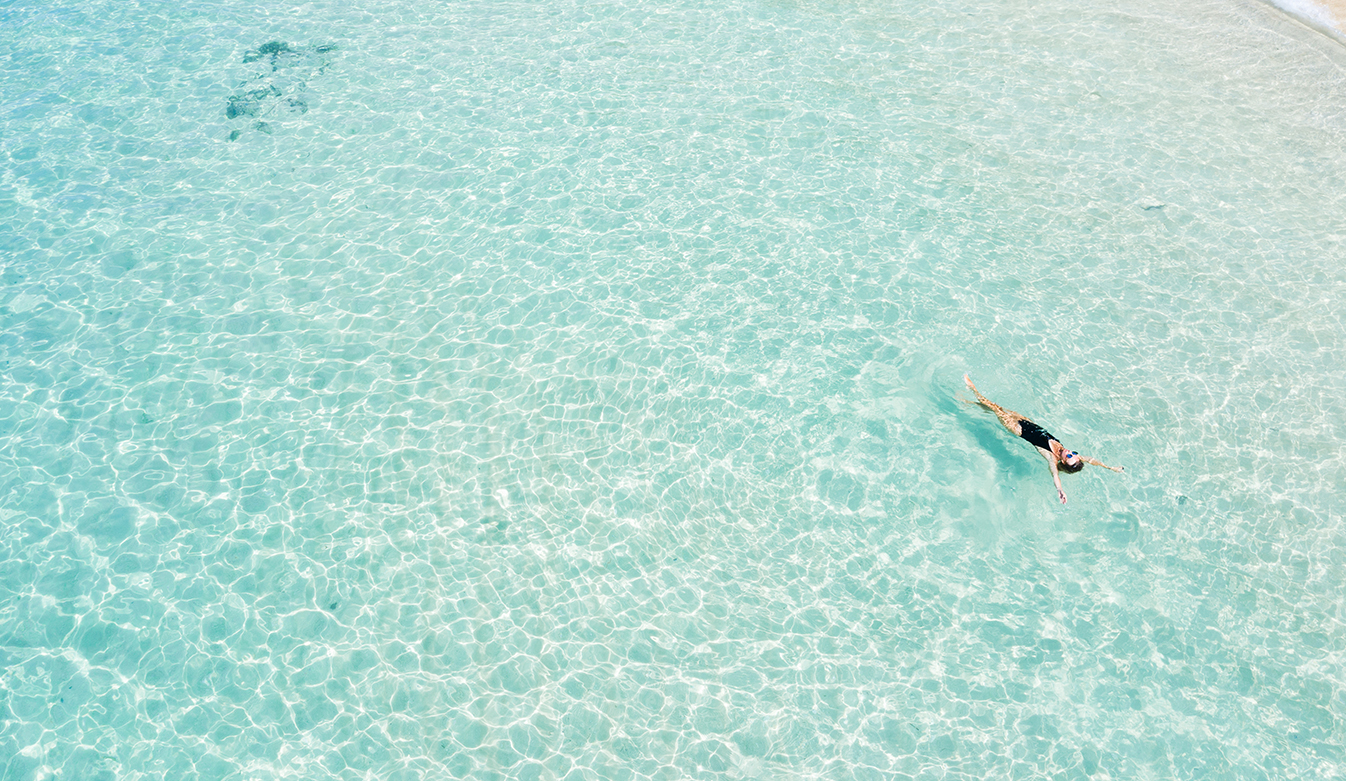 a person swimming in clear water
