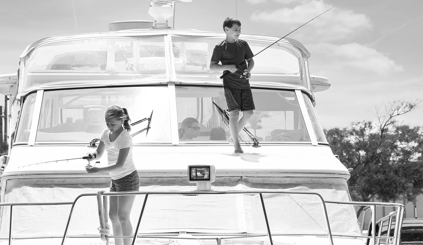 a boy and girl fishing on a boat