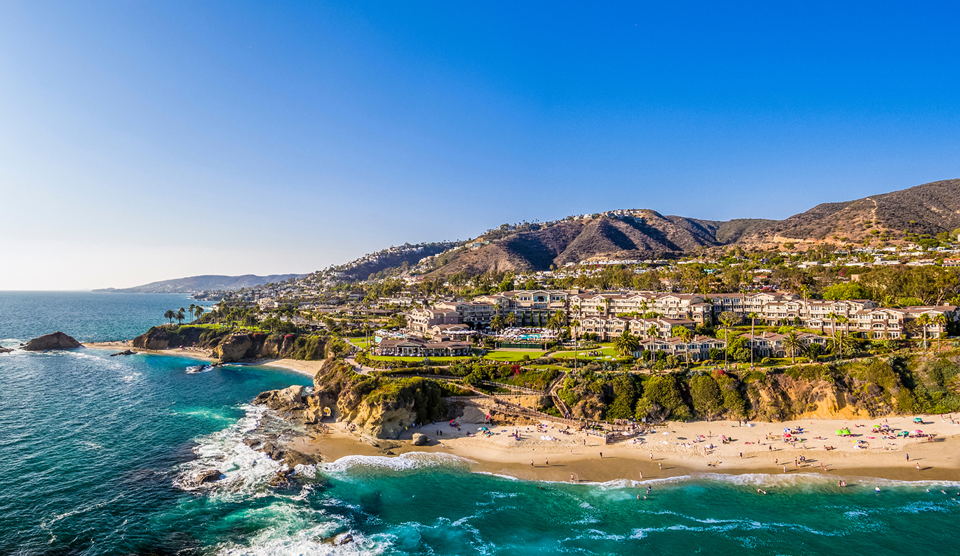 a beach with buildings and a body of water