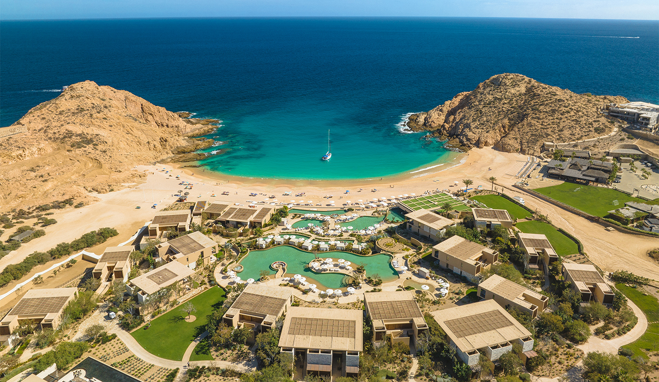 a beach with buildings and a body of water