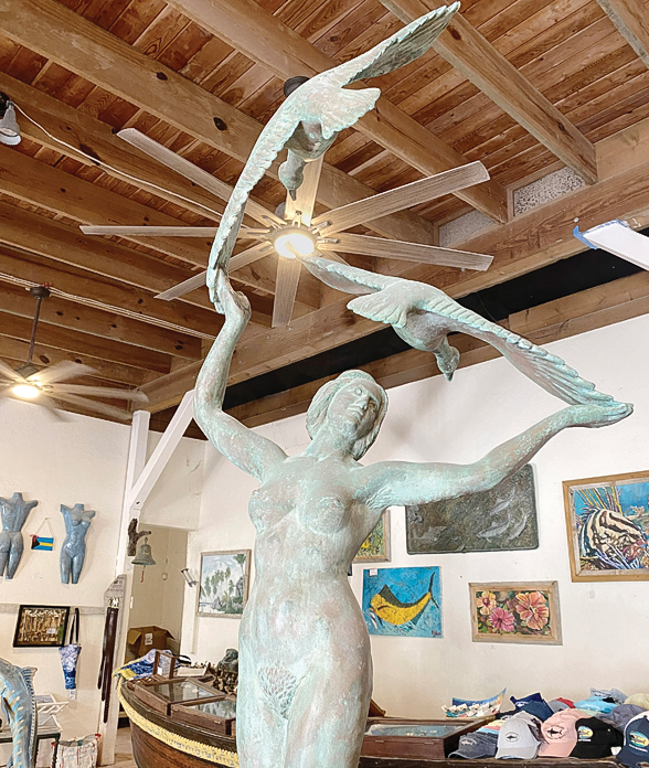 a statue of a woman holding birds