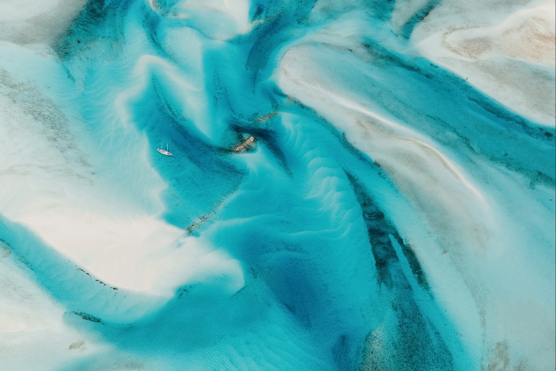 a blue water with a couple of boats