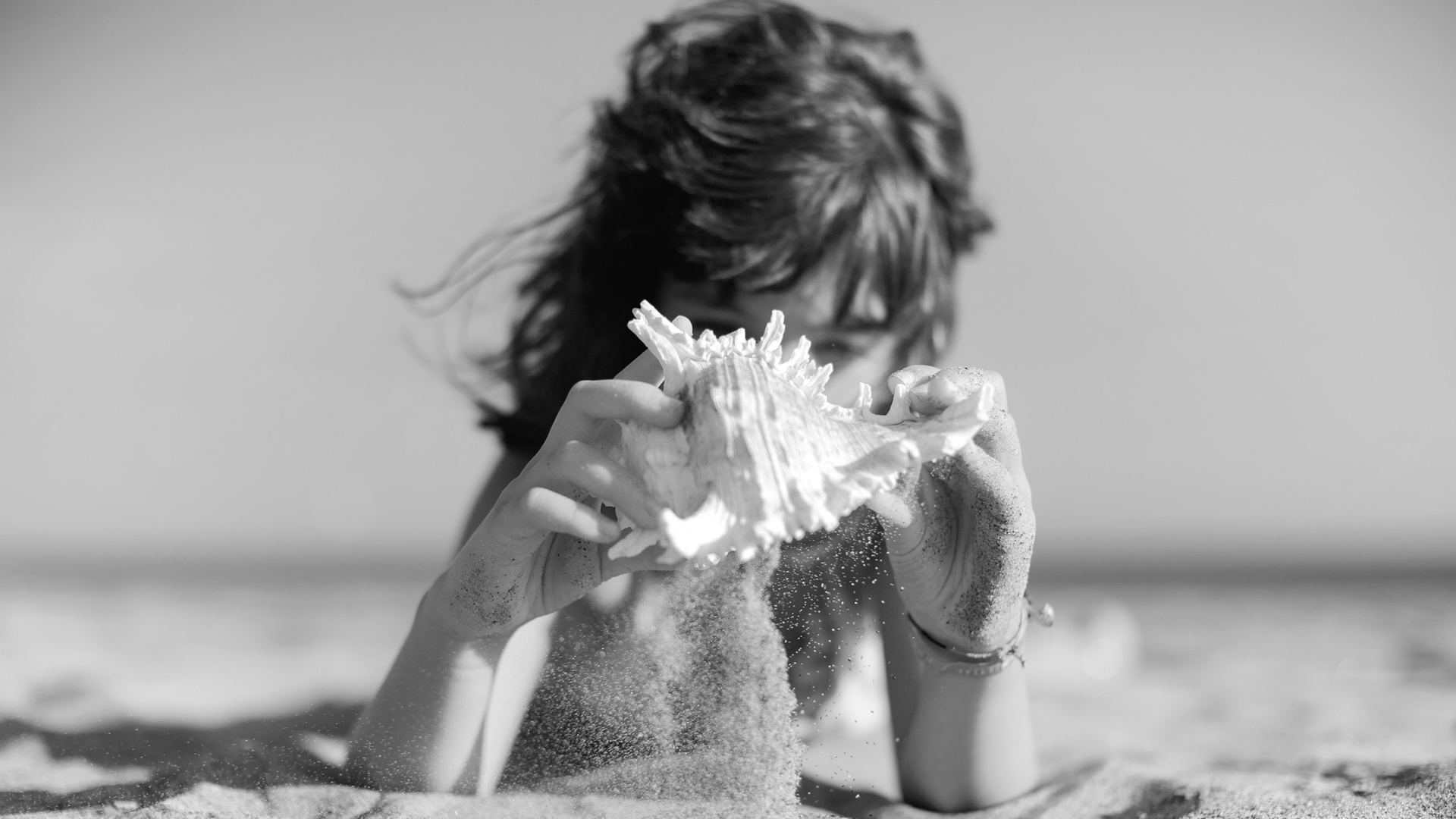 a person holding a seashell