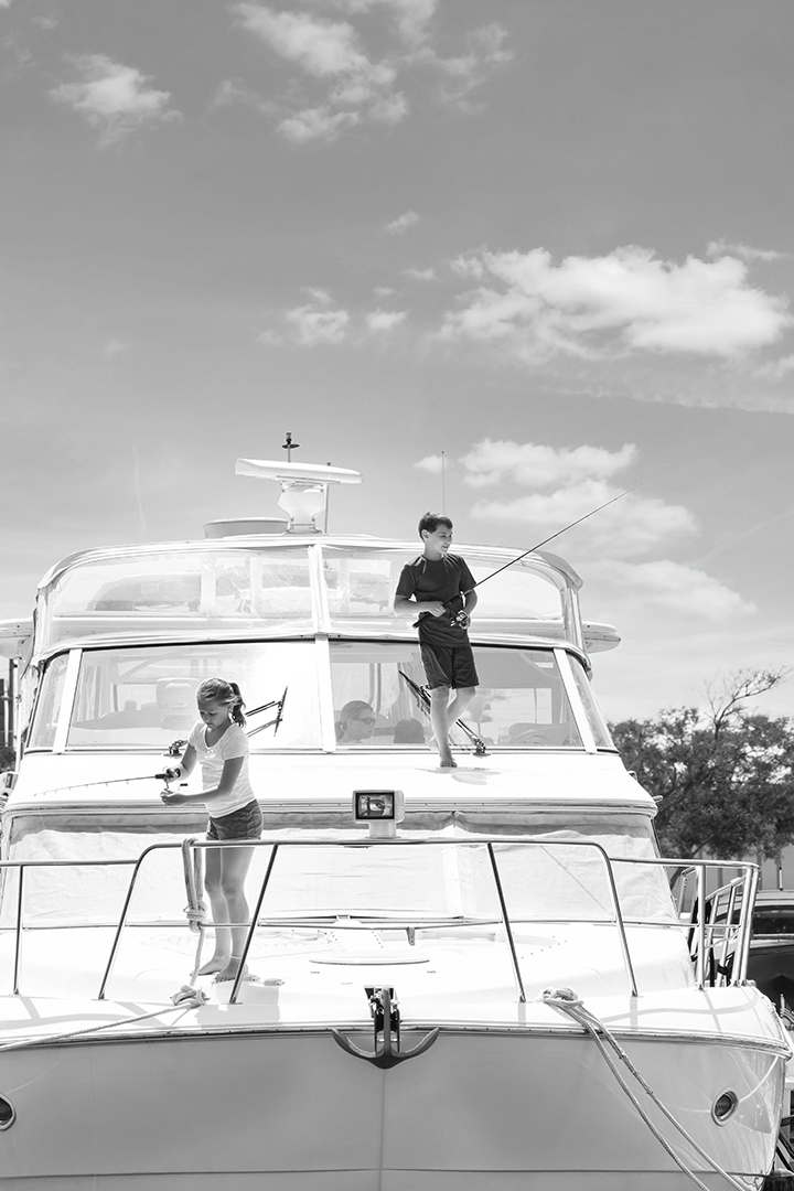 a boy and girl fishing on a boat