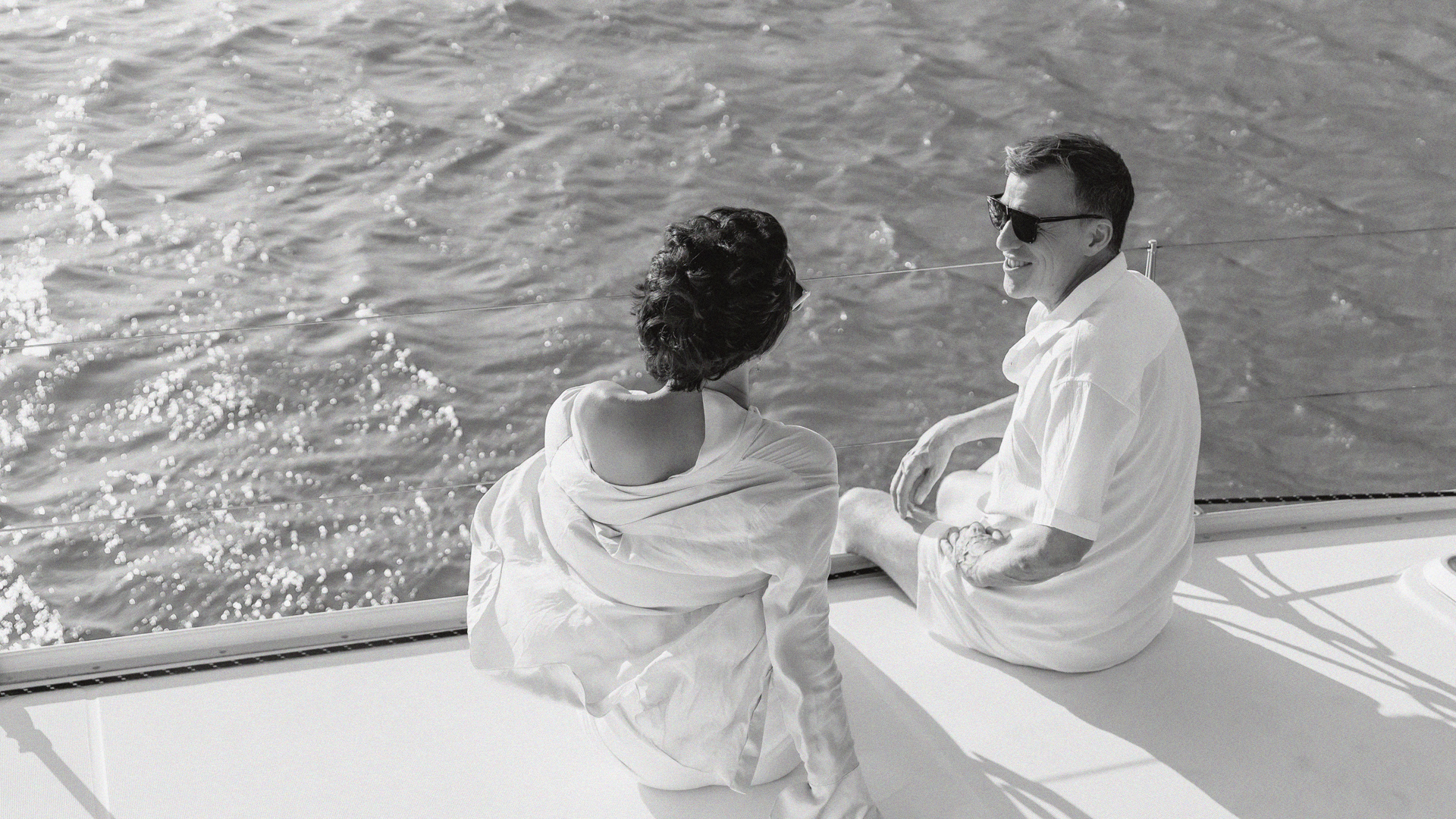 a man and woman sitting on a boat