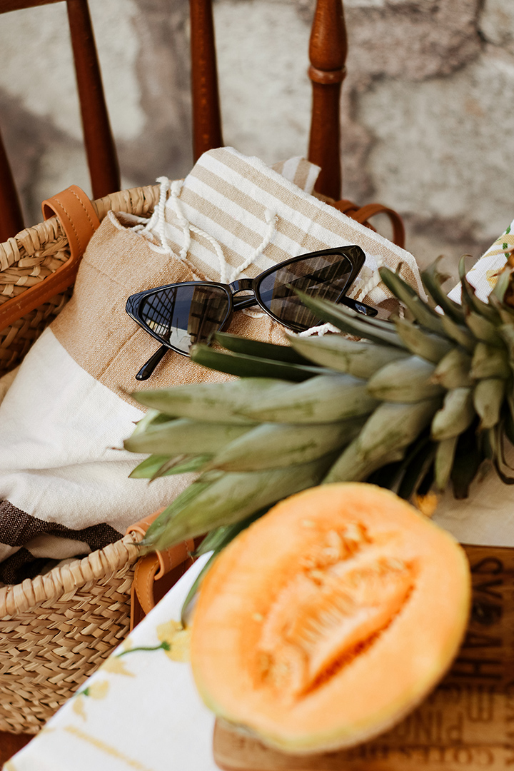 a basket with sunglasses and fruit