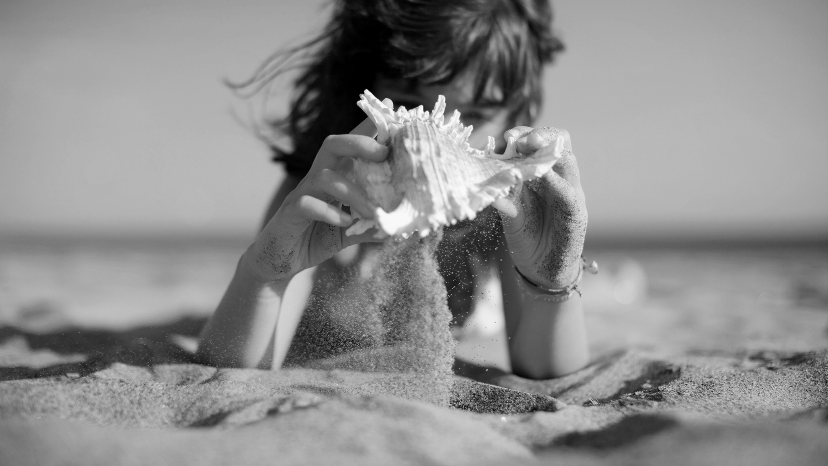 a person holding a seashell