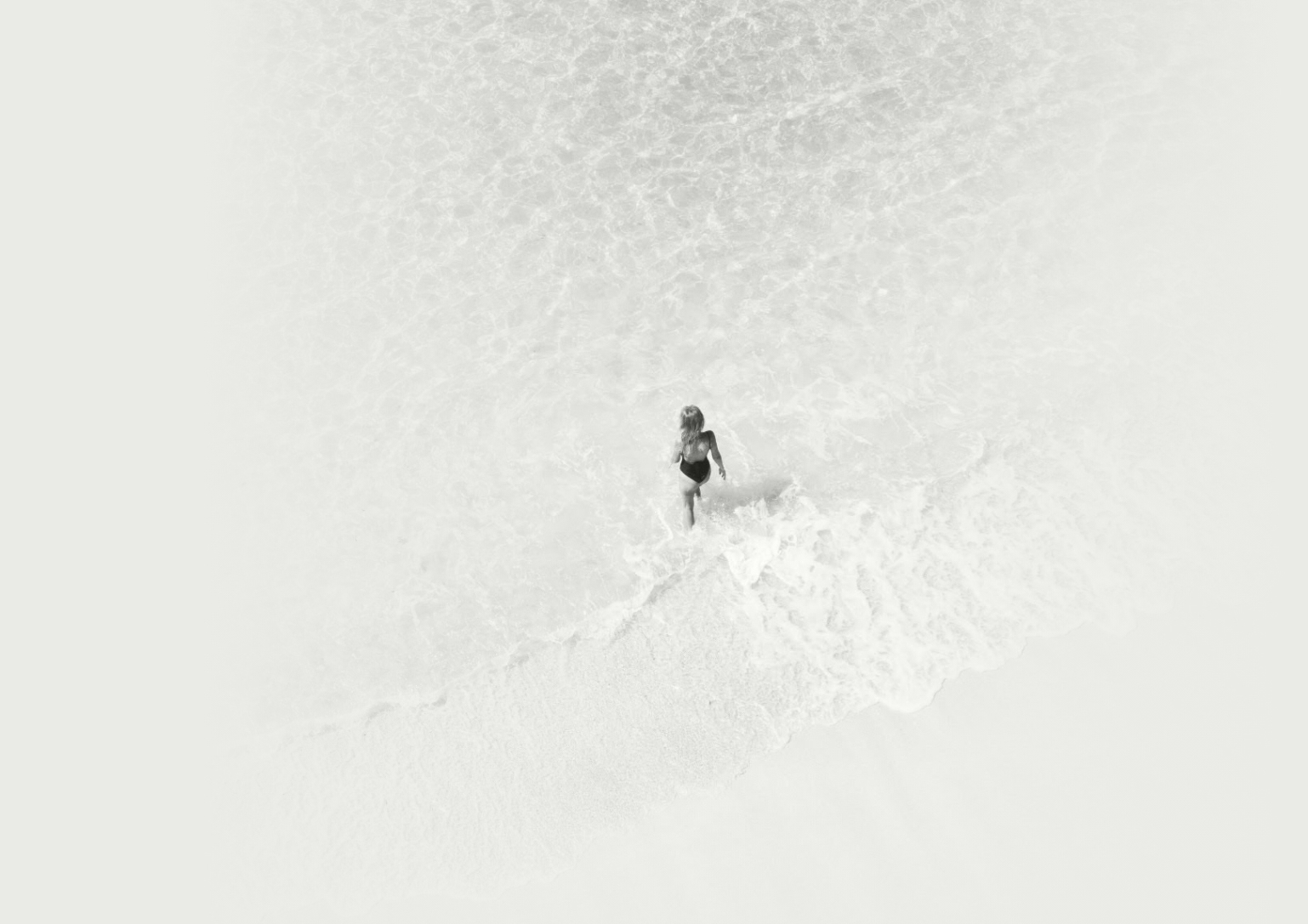 a woman in a bathing suit standing in the water