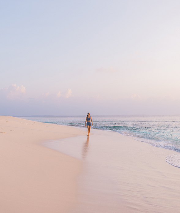 a woman walking on a beach