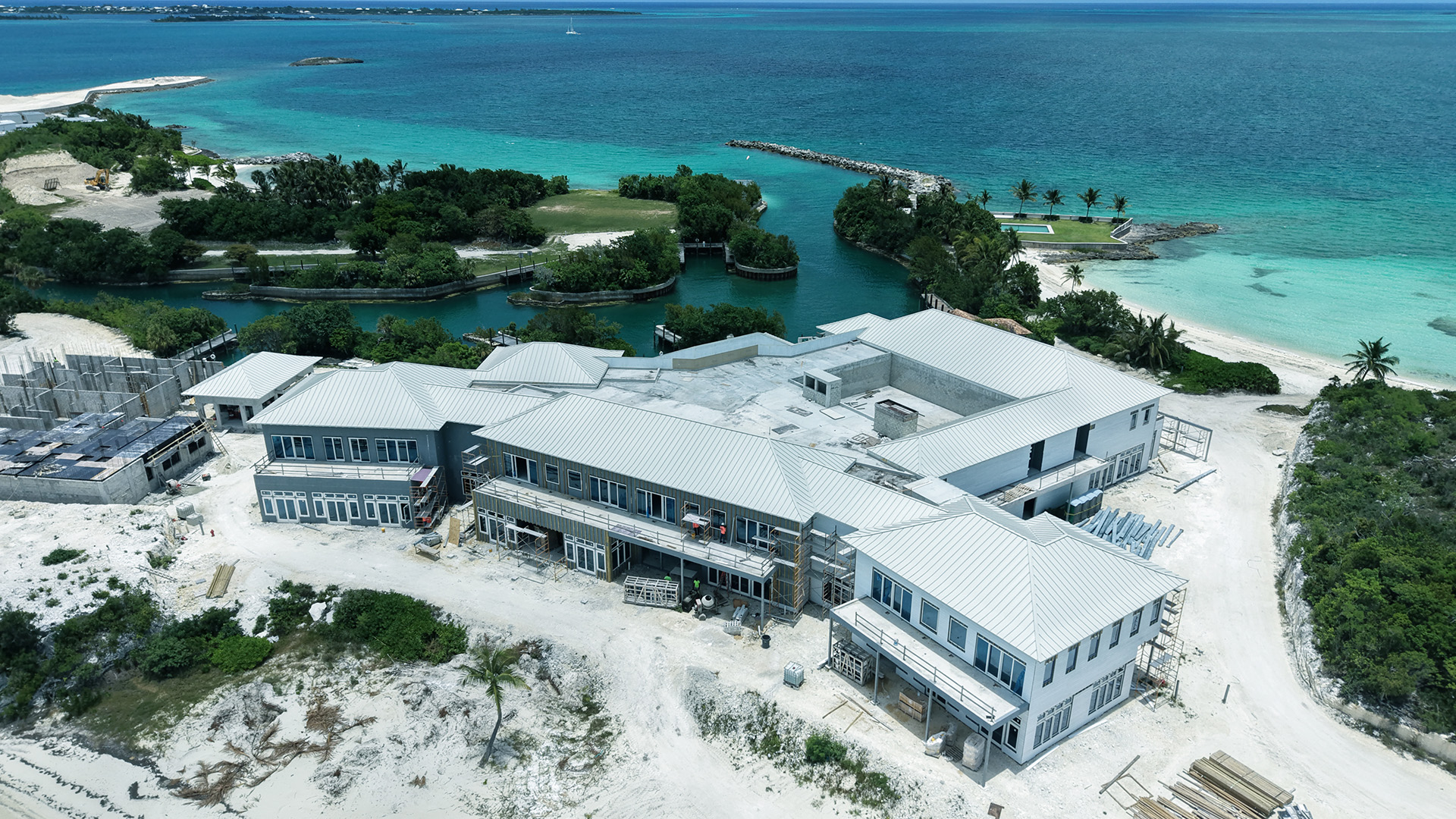 a large building with a body of water in the background