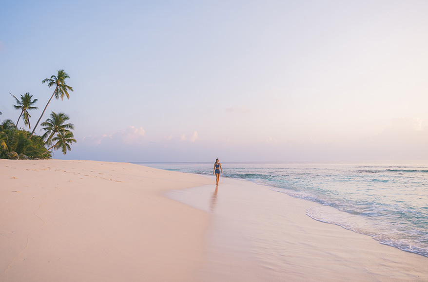 a woman walking on a beach