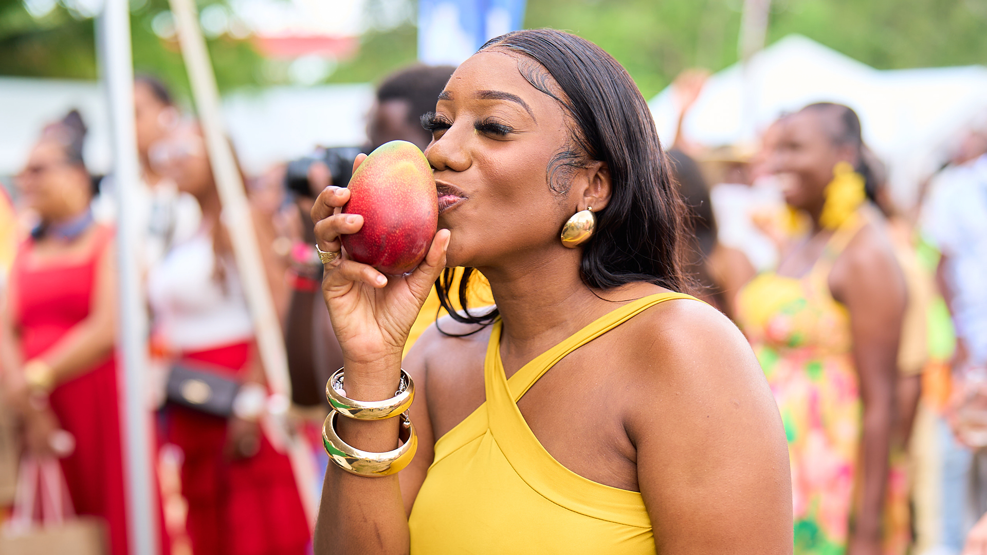 a woman holding a mango