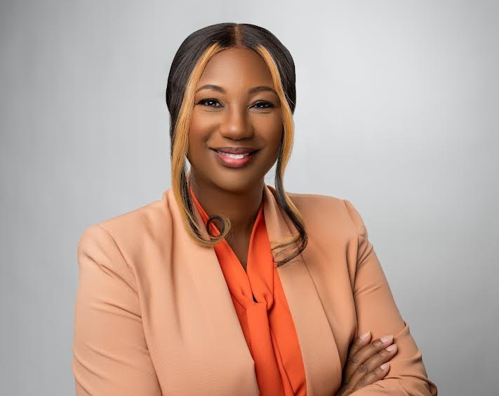 a woman in a suit with her arms crossed