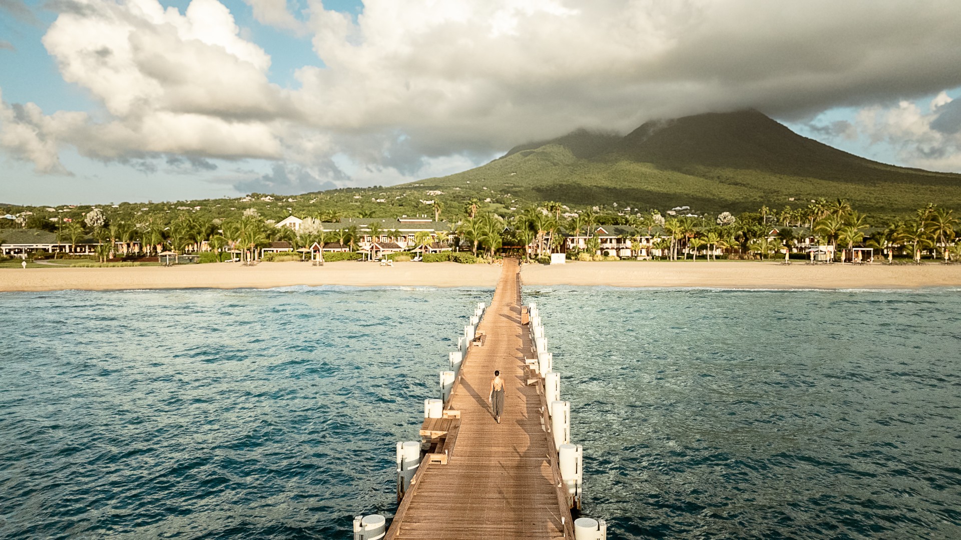 a person walking on a dock over water