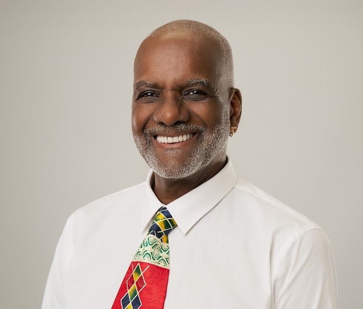 a man smiling at the camera