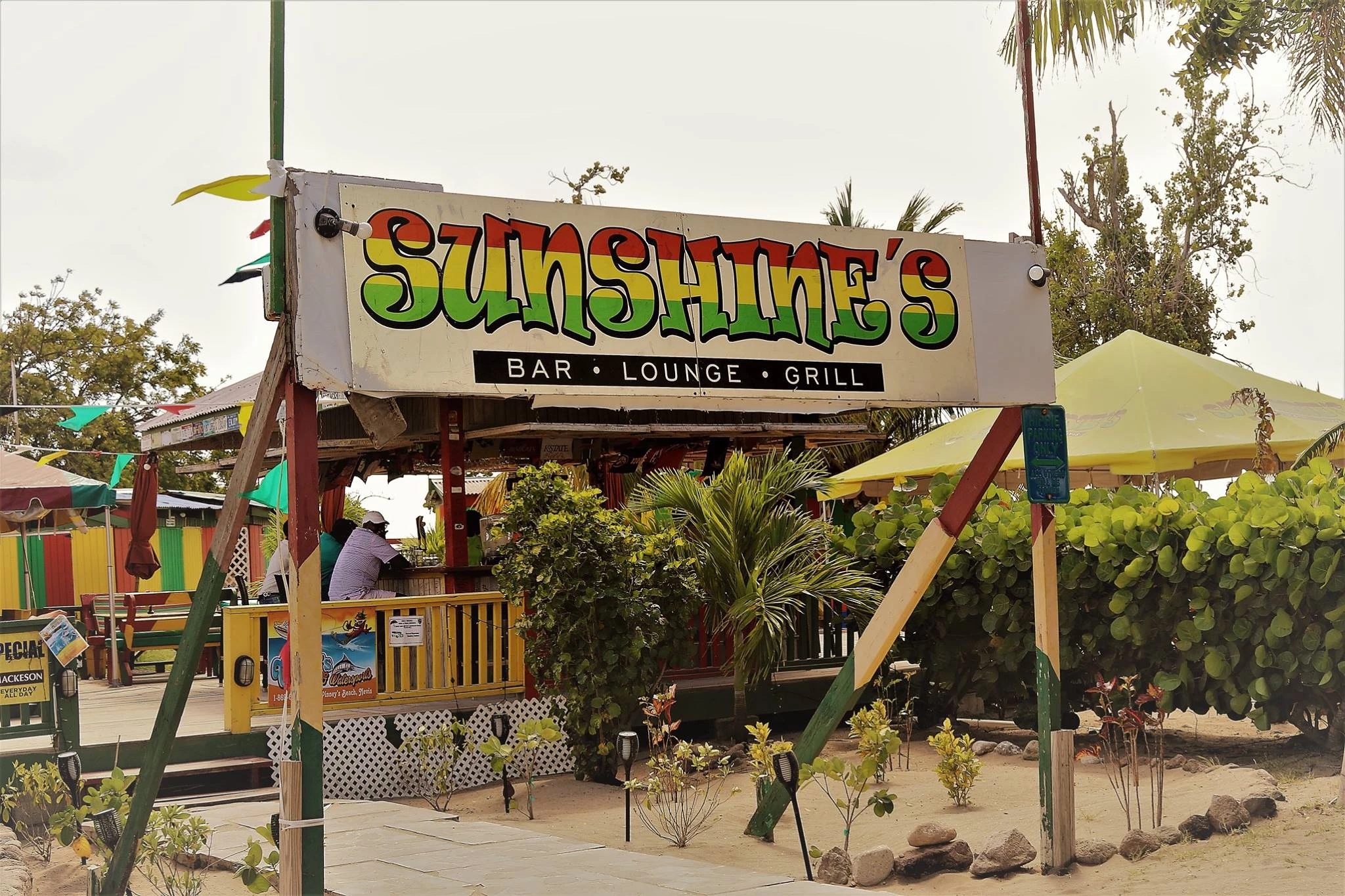 a sign with a bar and a bar in the background