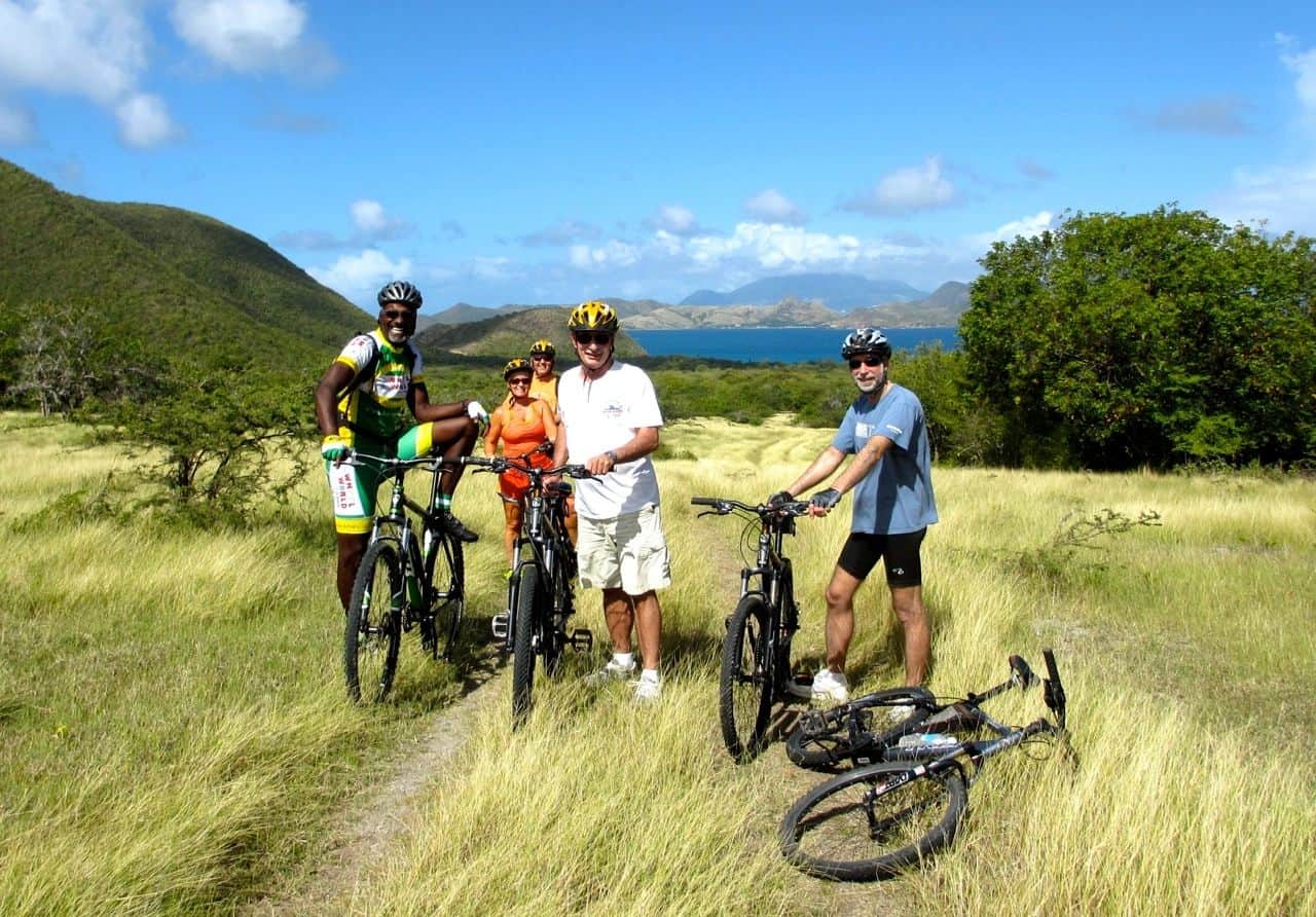a group of people on bicycles in a grassy field