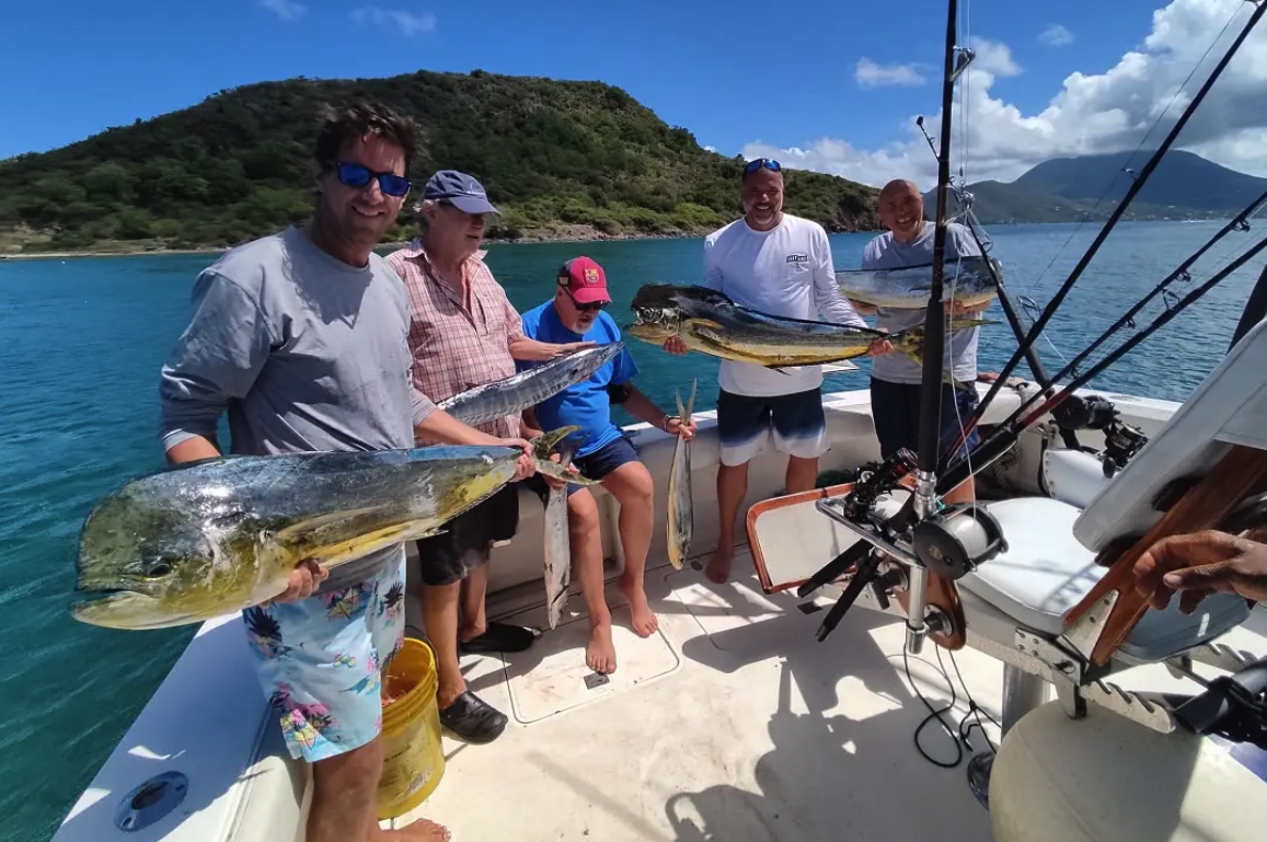 a group of men holding fish on a boat