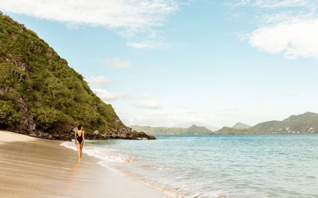 a woman walking on a beach