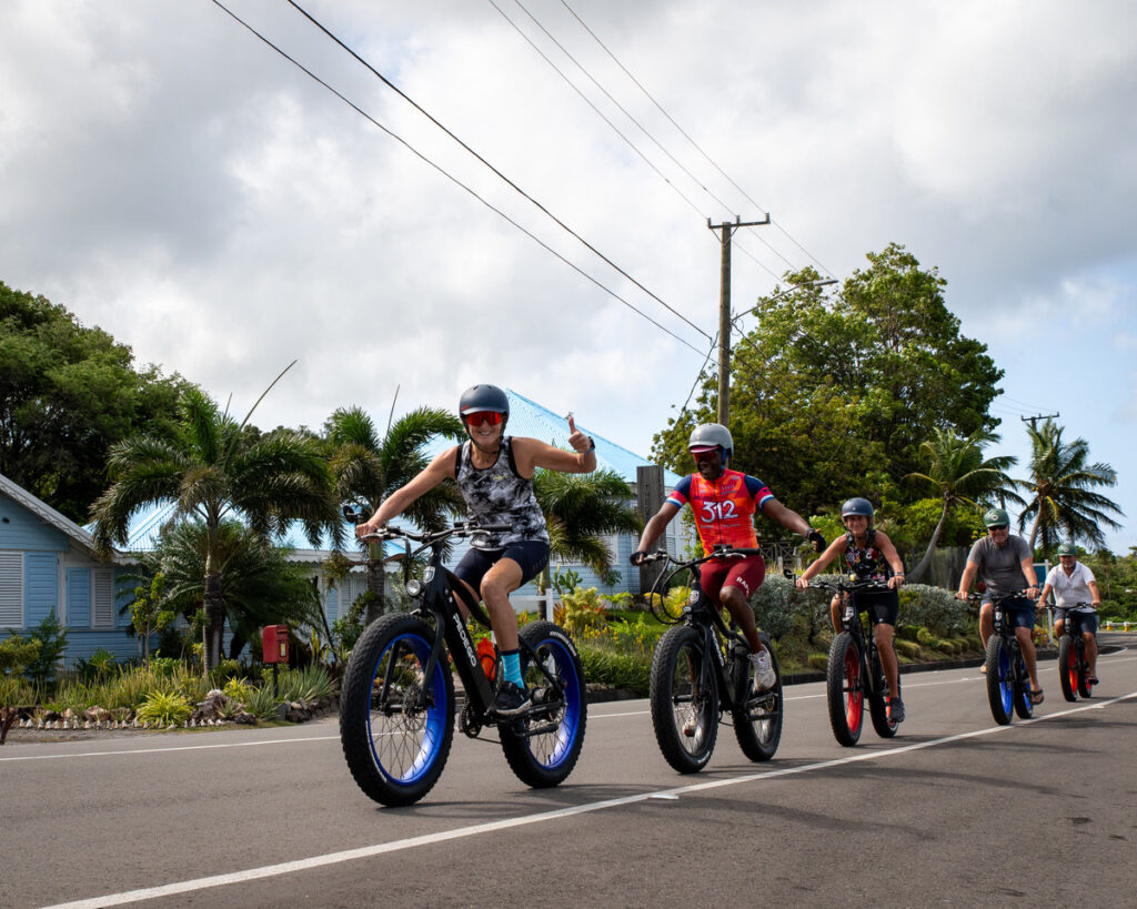 a group of people riding bikes on a road