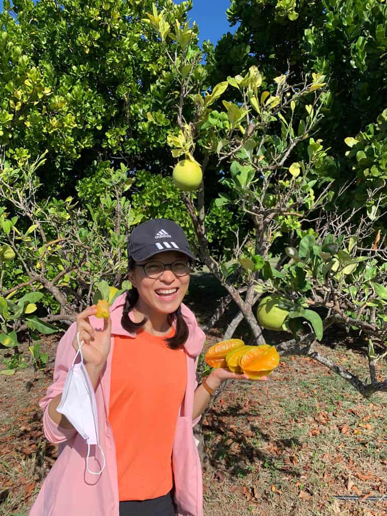 a woman holding fruit in her hand